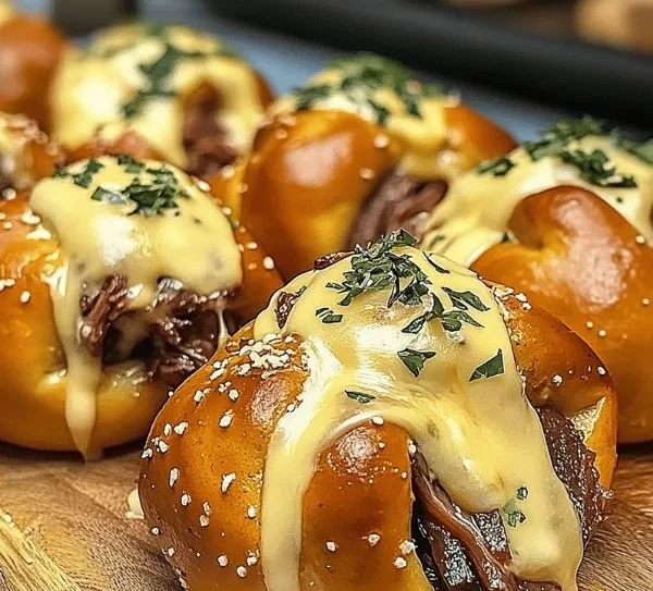 Brisket pretzel bombs stuffed with beer cheese for a delicious game day treat.
