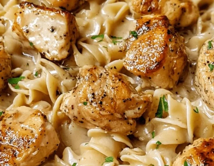 One-Pan Creamy Garlic Butter Chicken served with Egg Noodles in a skillet